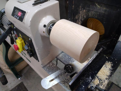 Turning the maple wood base on the lathe