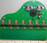 bottom side of first piano prototype with small coin type batteries