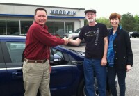 Evan (salesman) with Guy and Becky in front of Volt at the dealers