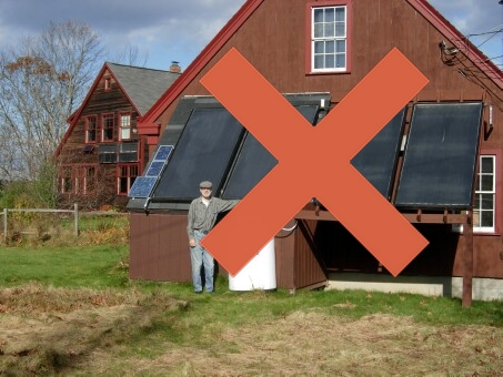 Guy in front of solar heated barn