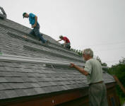 Guyu,John and Tom installing rails on the roof