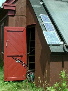 Mower plugged in to solar panels and charging from the sun