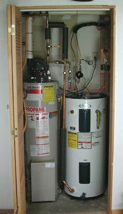 utility closet showing propane water heater and solar storage tank