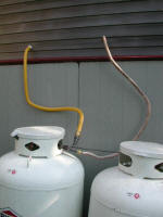 new 1 inch flexible pipe terminates in a T at the propane tanks