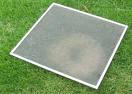 window screen laying on grass